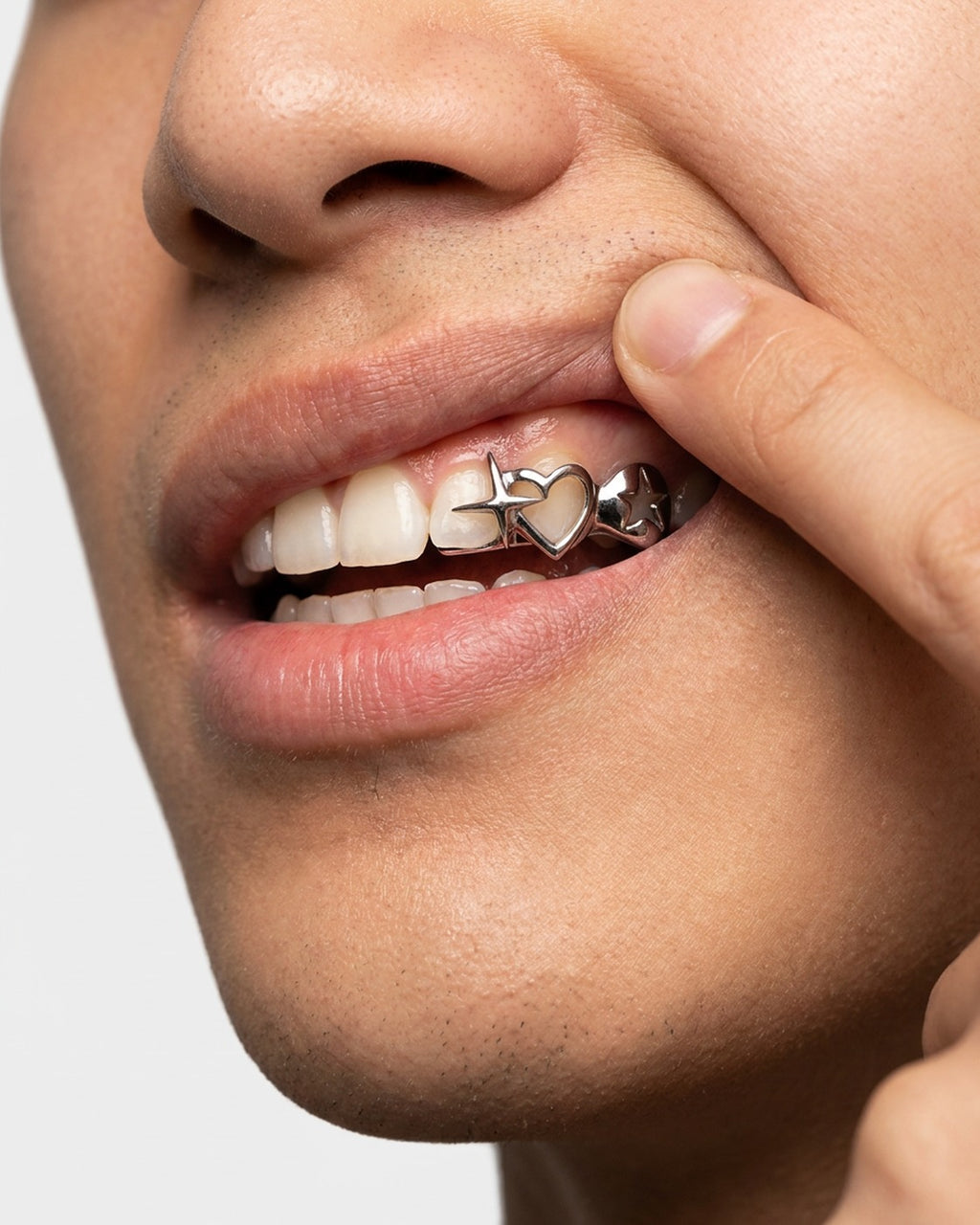 Heart & Star Grillz worn – single tooth heart and star grillz styled in a streetwear outfit