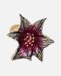 Black Star Flower Ring – black star flower ring with red centre, product photo on grey background