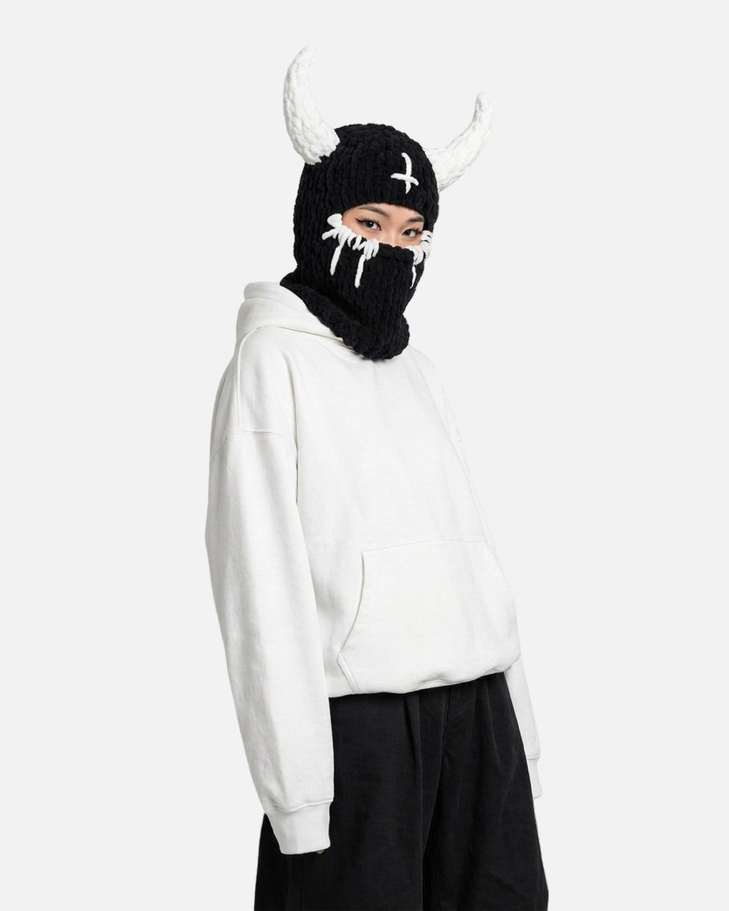 White Horn Demon Balaclava worn – black knit demon balaclava with white horns styled in a streetwear outfit